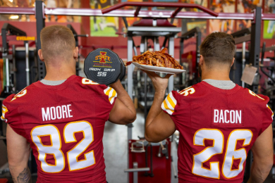 Football players with Moore and Bacon on the backs of t